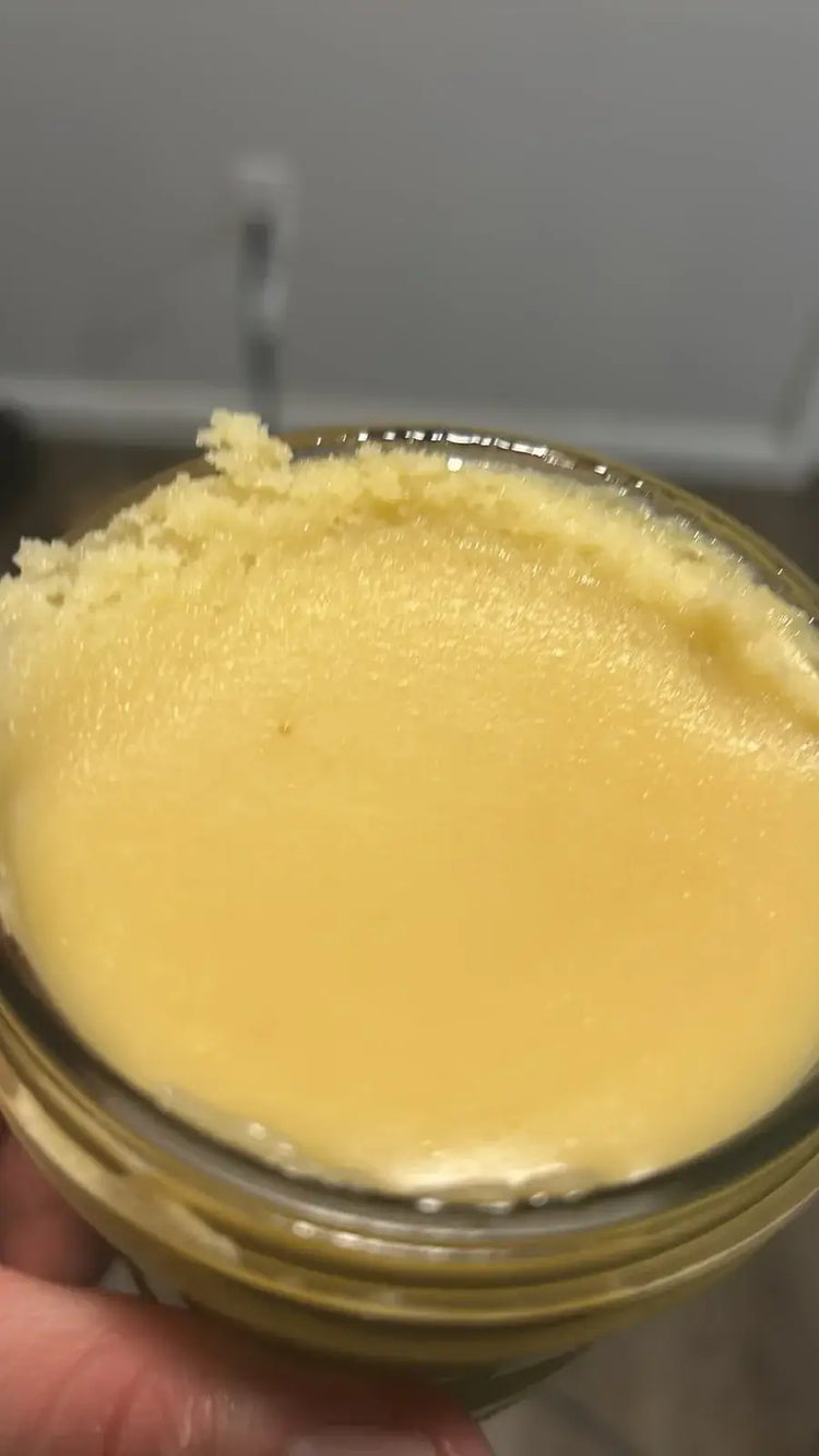 A clear glass jar filled with smooth creamy yellow thca live resin badder weighing 14 grams